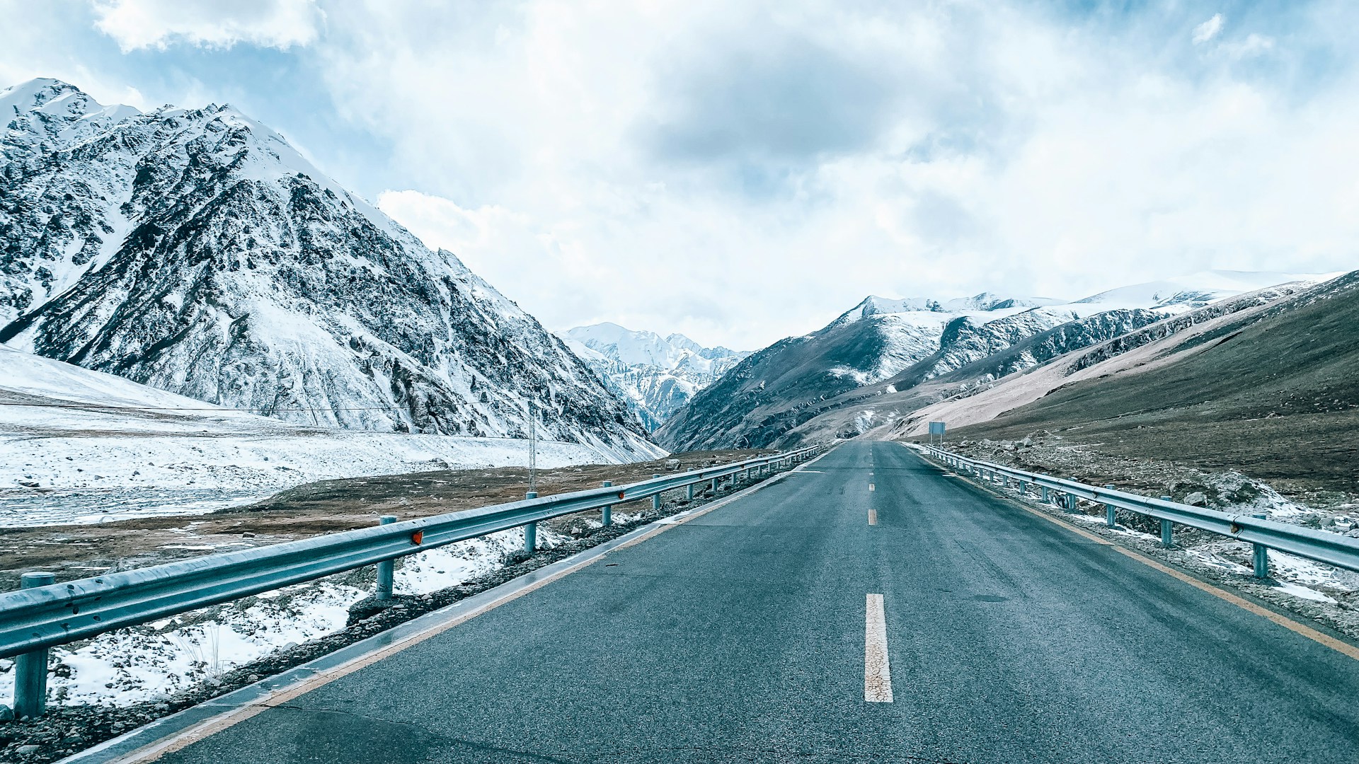 a long road with a mountain in the background