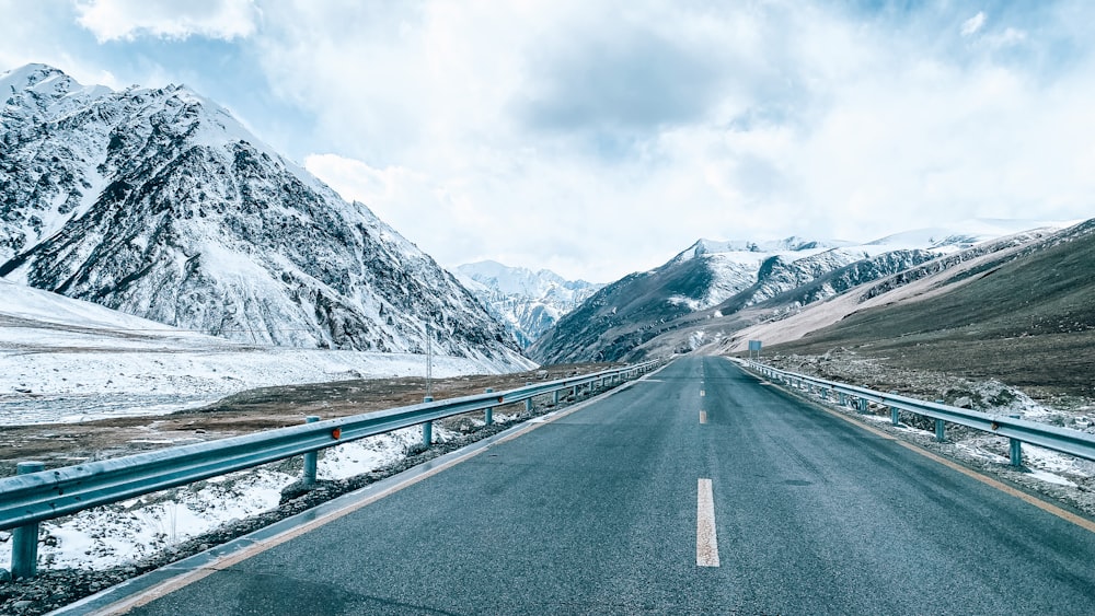 a long road with a mountain in the background