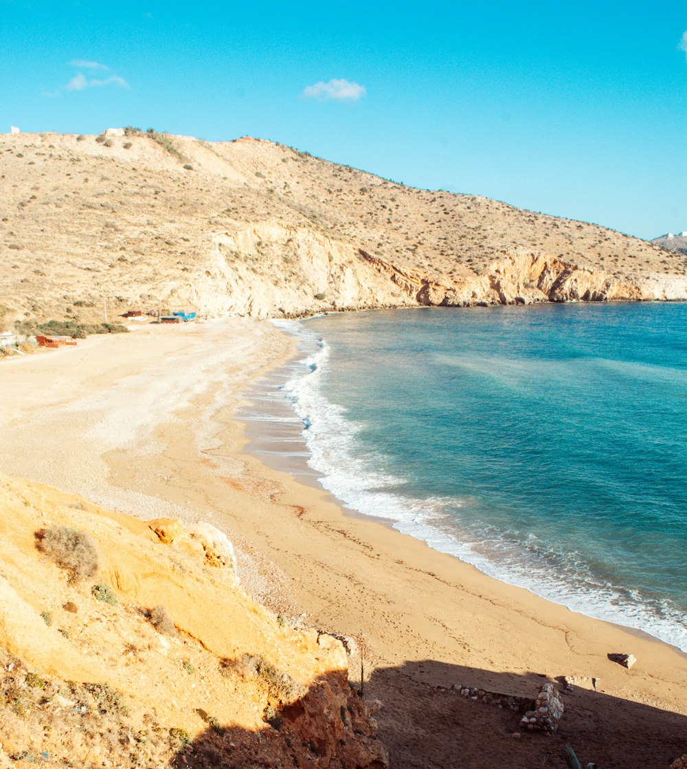 a view of a beach with a mountain in the background