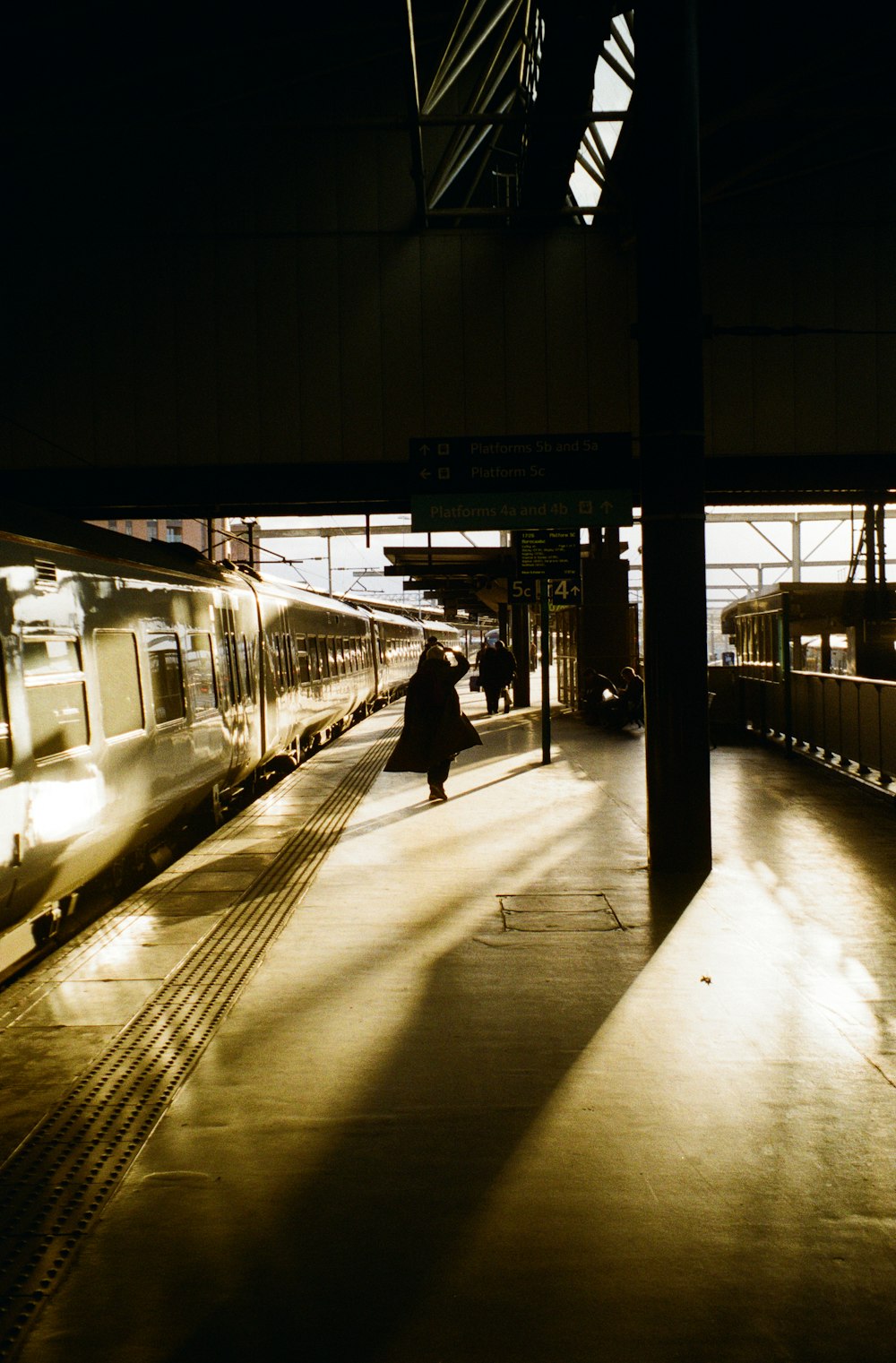 a train station with a train pulling into the station