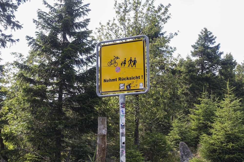 a yellow sign that is on the side of a road