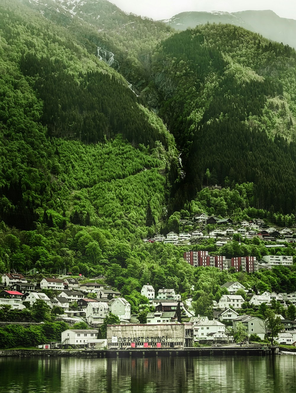 a scenic view of a small town on a mountain