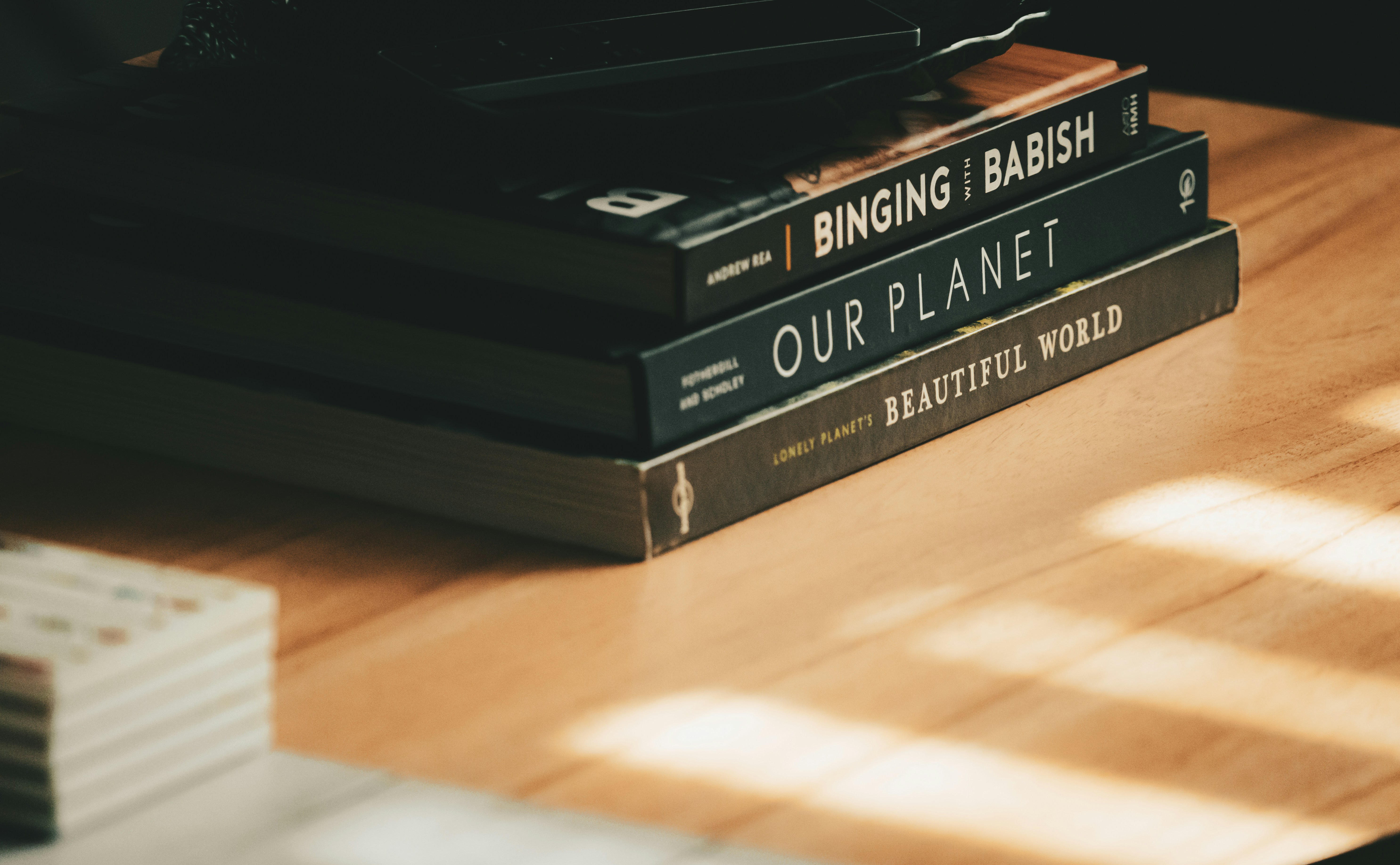 a stack of books sitting on top of a wooden table