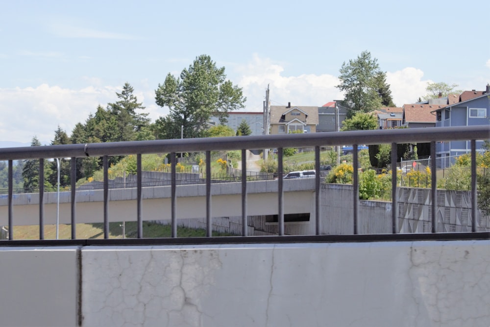 a view of a bridge over a river with houses in the background