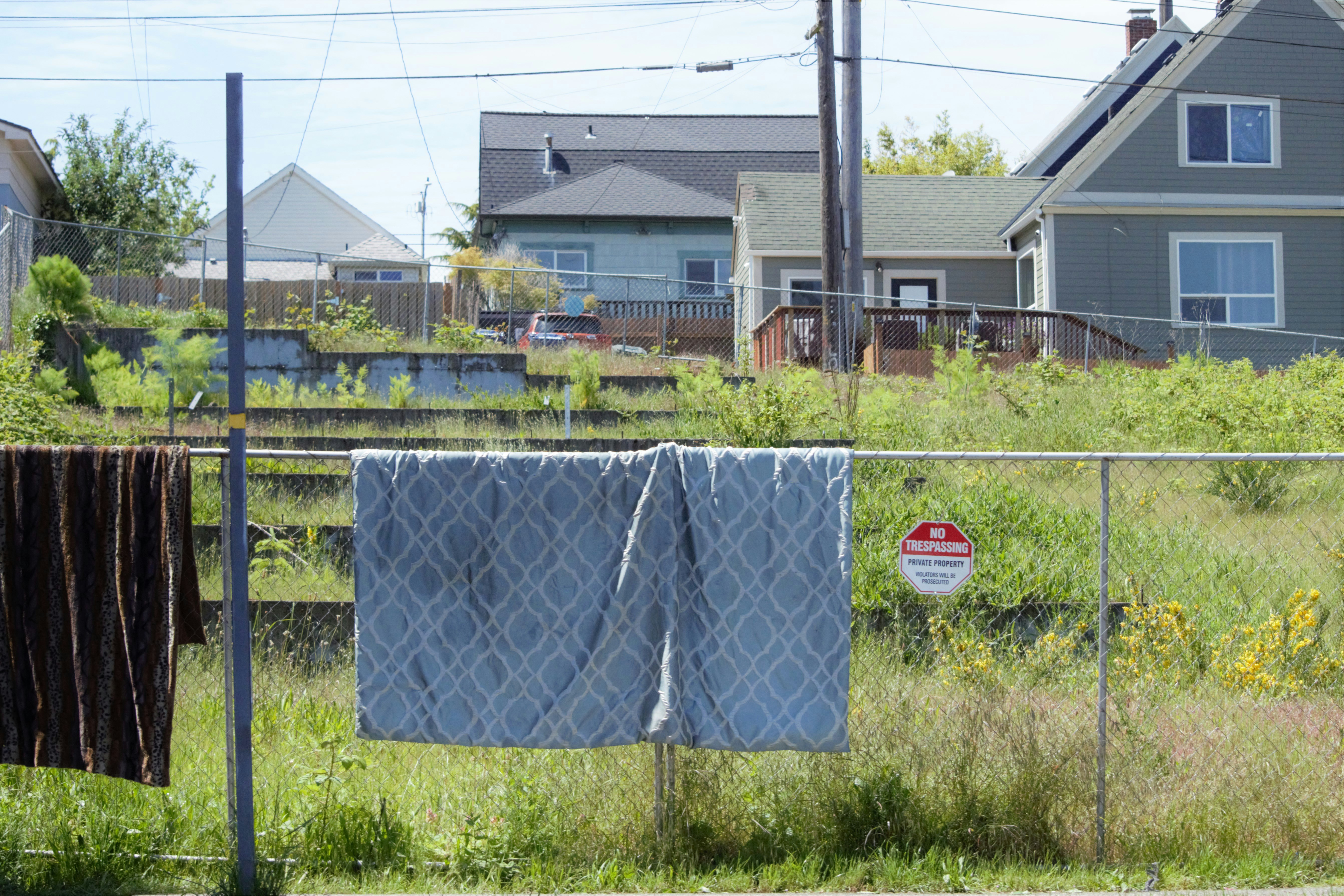 a fenced in yard with a towel hanging on it