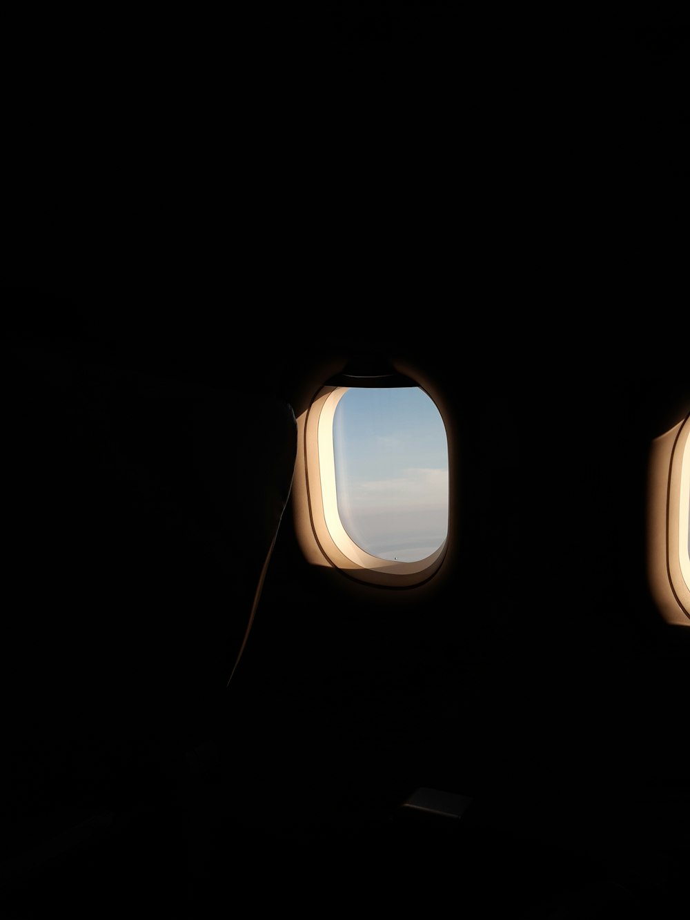 an airplane window with a view of the sky