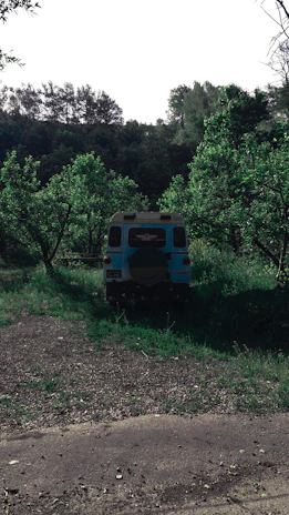 A Ketchum Air service van parked outside a customer's house surrounded by green trees.