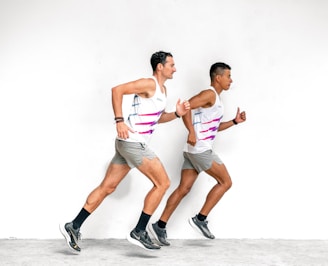 a couple of men running next to each other