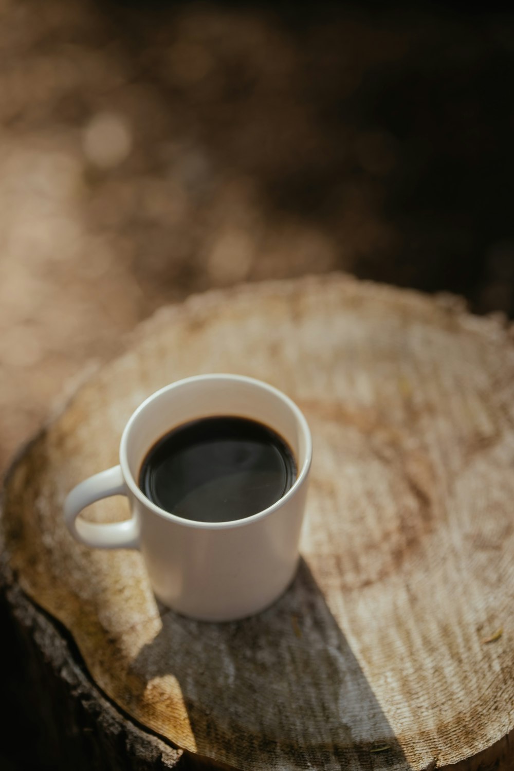 a cup of coffee sitting on top of a wooden table