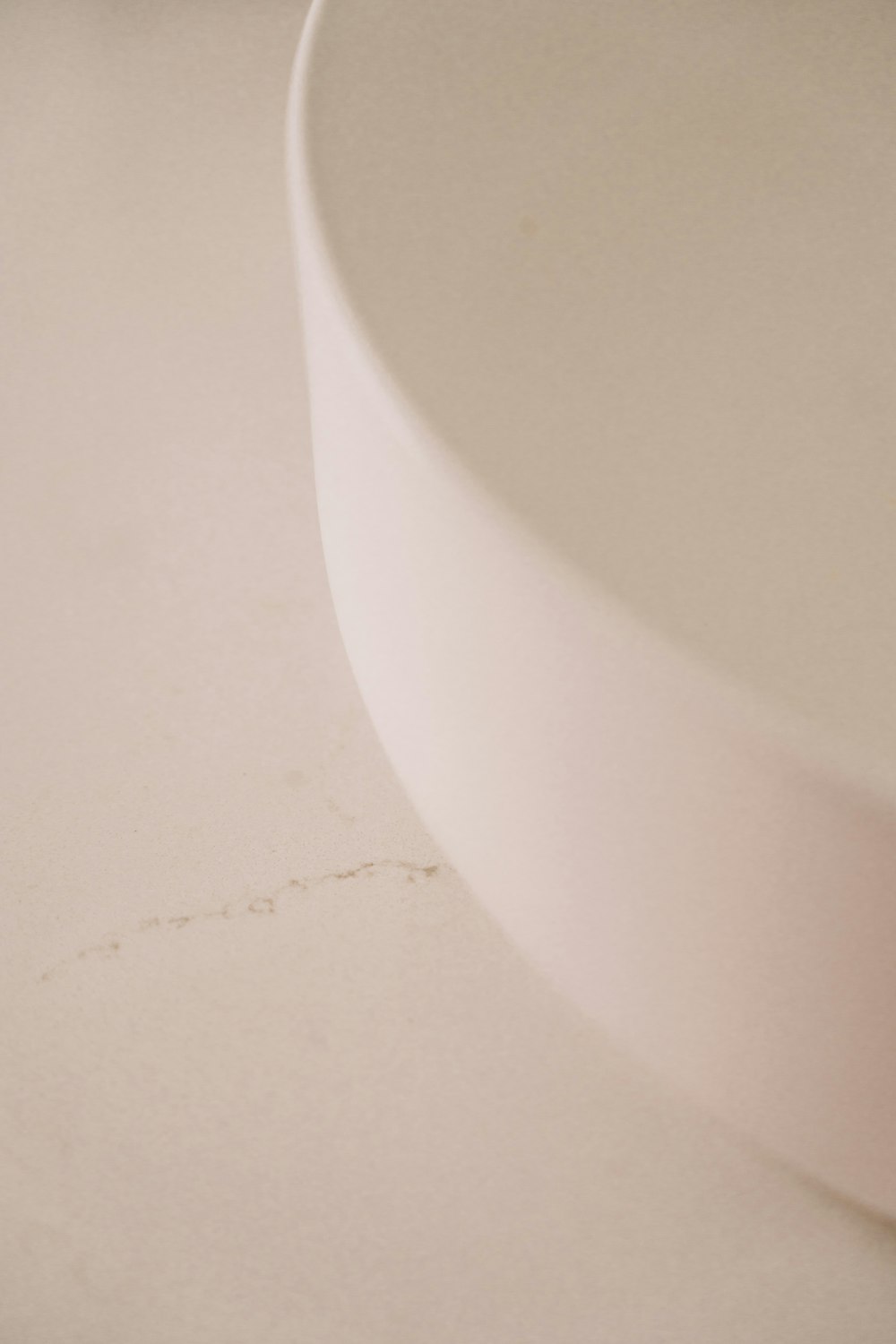 a white bowl sitting on top of a white counter
