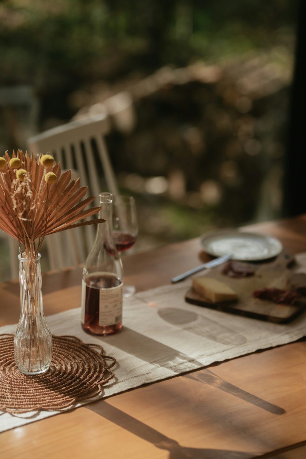 a wooden table topped with a vase filled with flowers