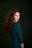 a woman with long red hair posing for a picture