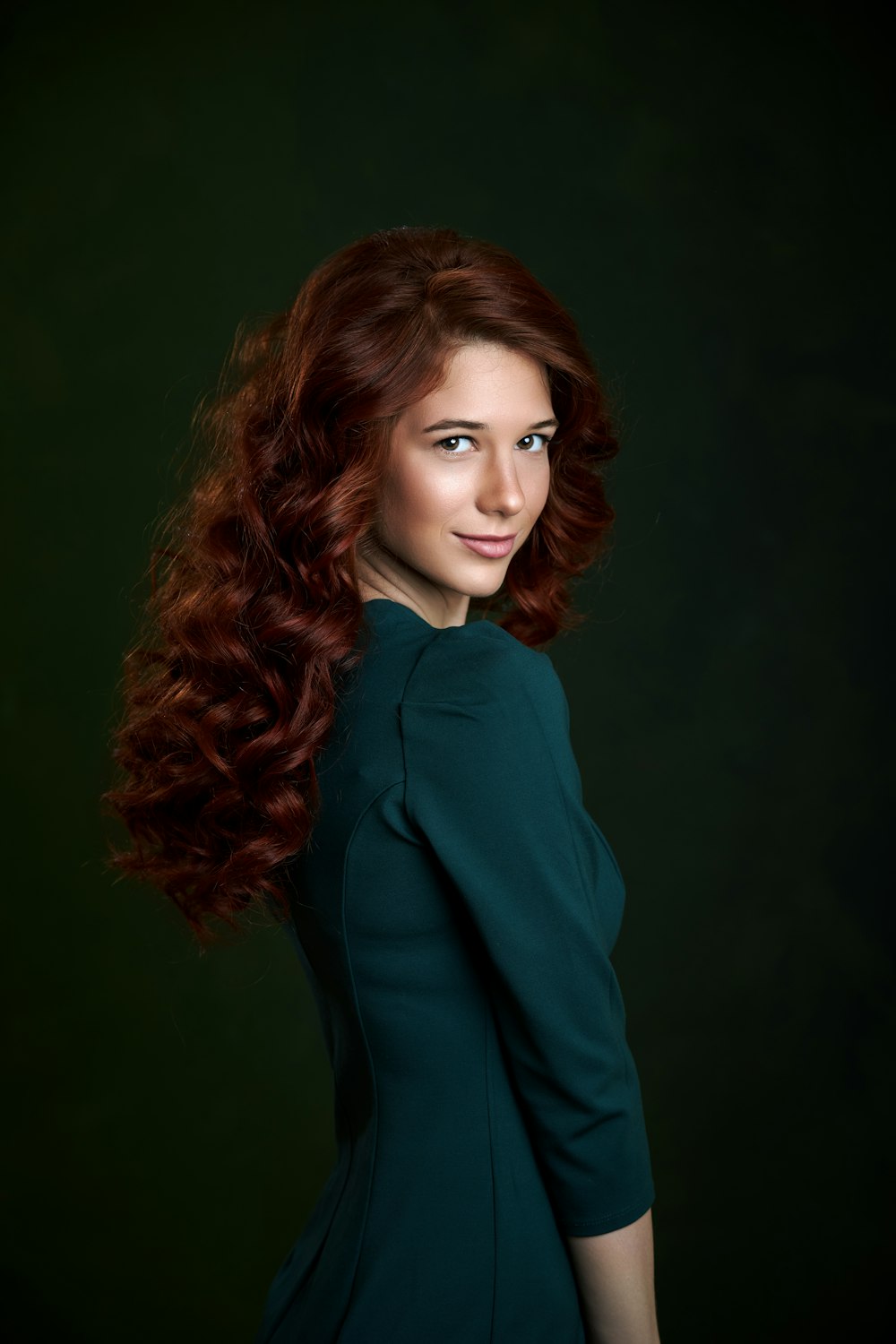 a woman with long red hair posing for a picture