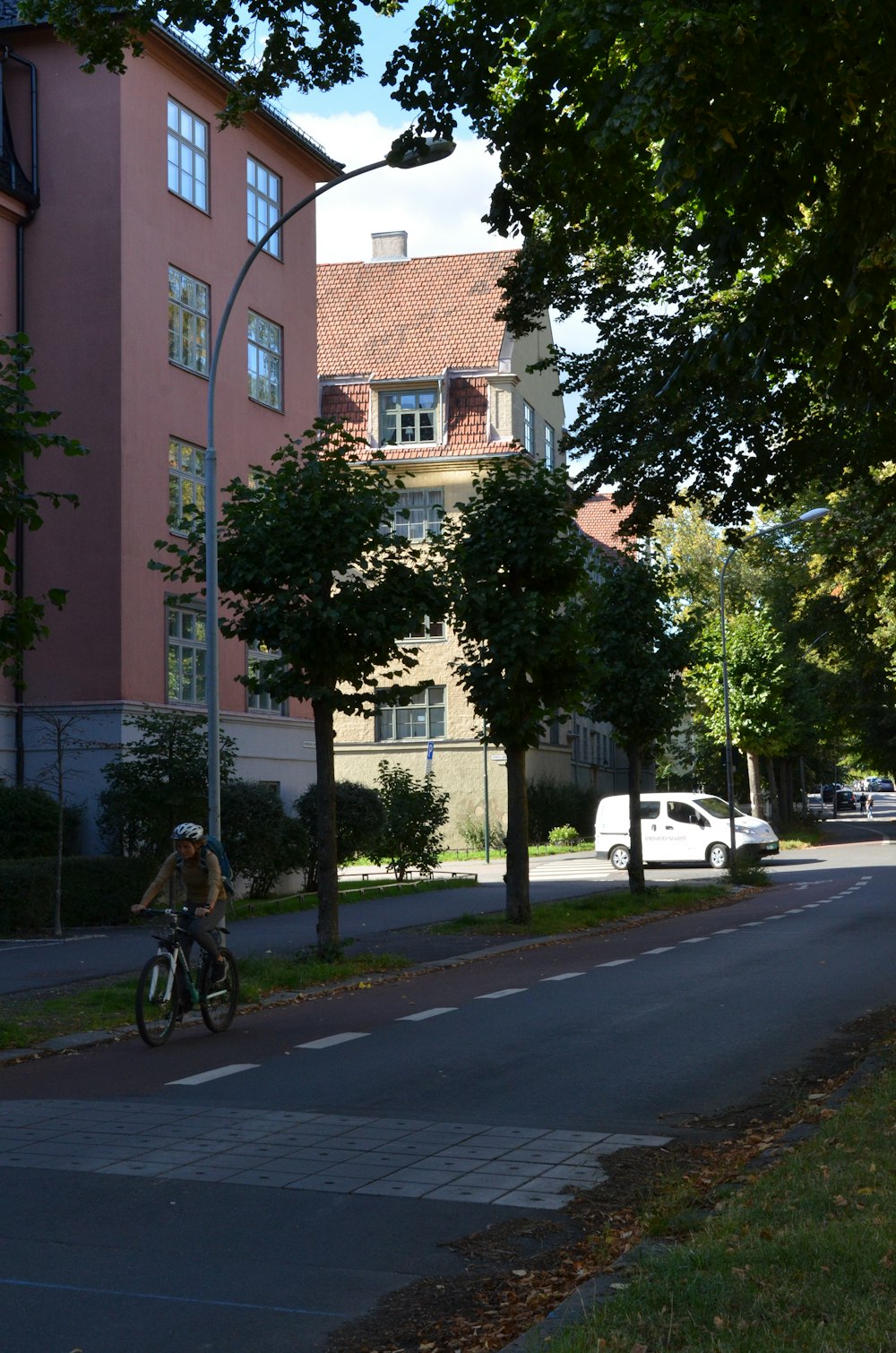 a person riding a bike on a city street