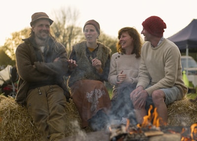 Footloosearther travelers laughing around a campfire beneath an open sky