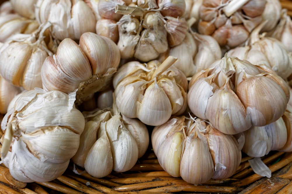 a basket filled with lots of garlic on top of a table