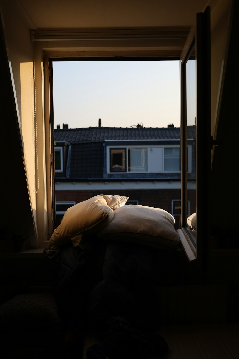 a bed sitting in a bedroom next to a window