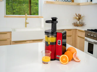 a juicer sitting on top of a white counter
