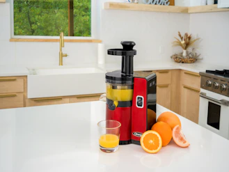 a juicer sitting on top of a white counter
