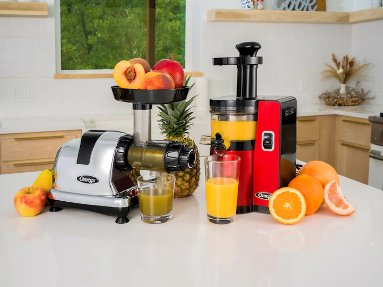 a kitchen counter with a juicer, blender, oranges, and a