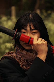 Dark-themed anime wallpaper featuring a mysterious figure with a katana.