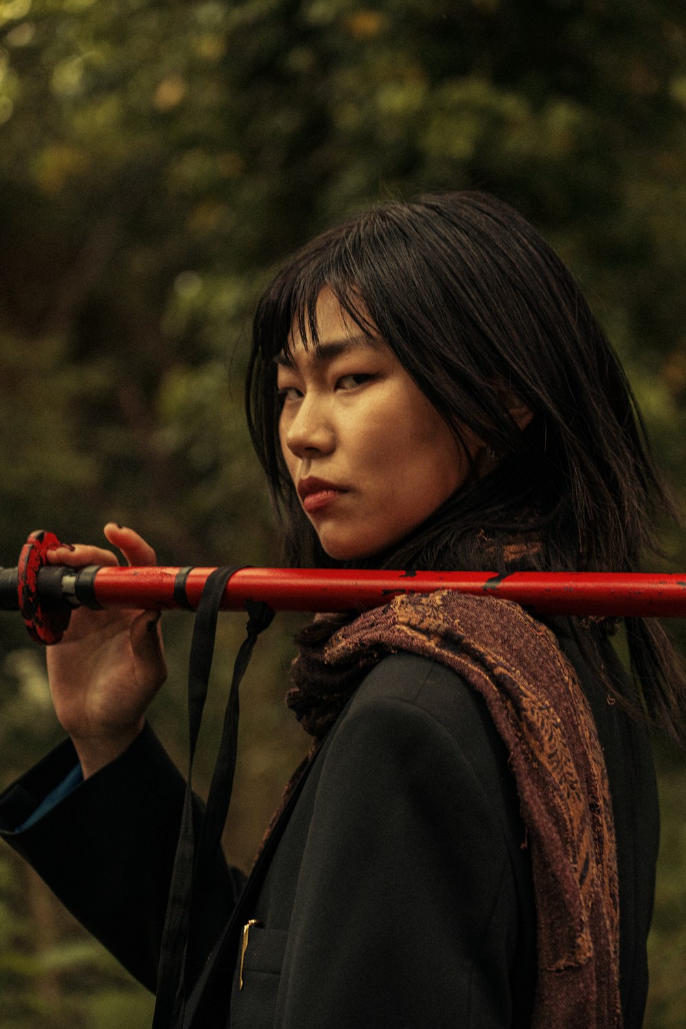 a woman holding a red stick in her hand