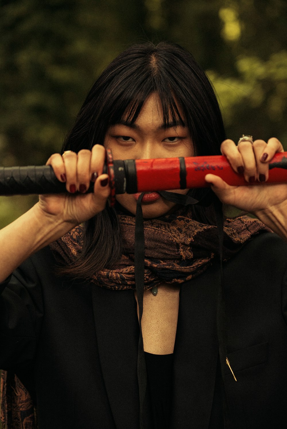 a woman holding a red umbrella over her head