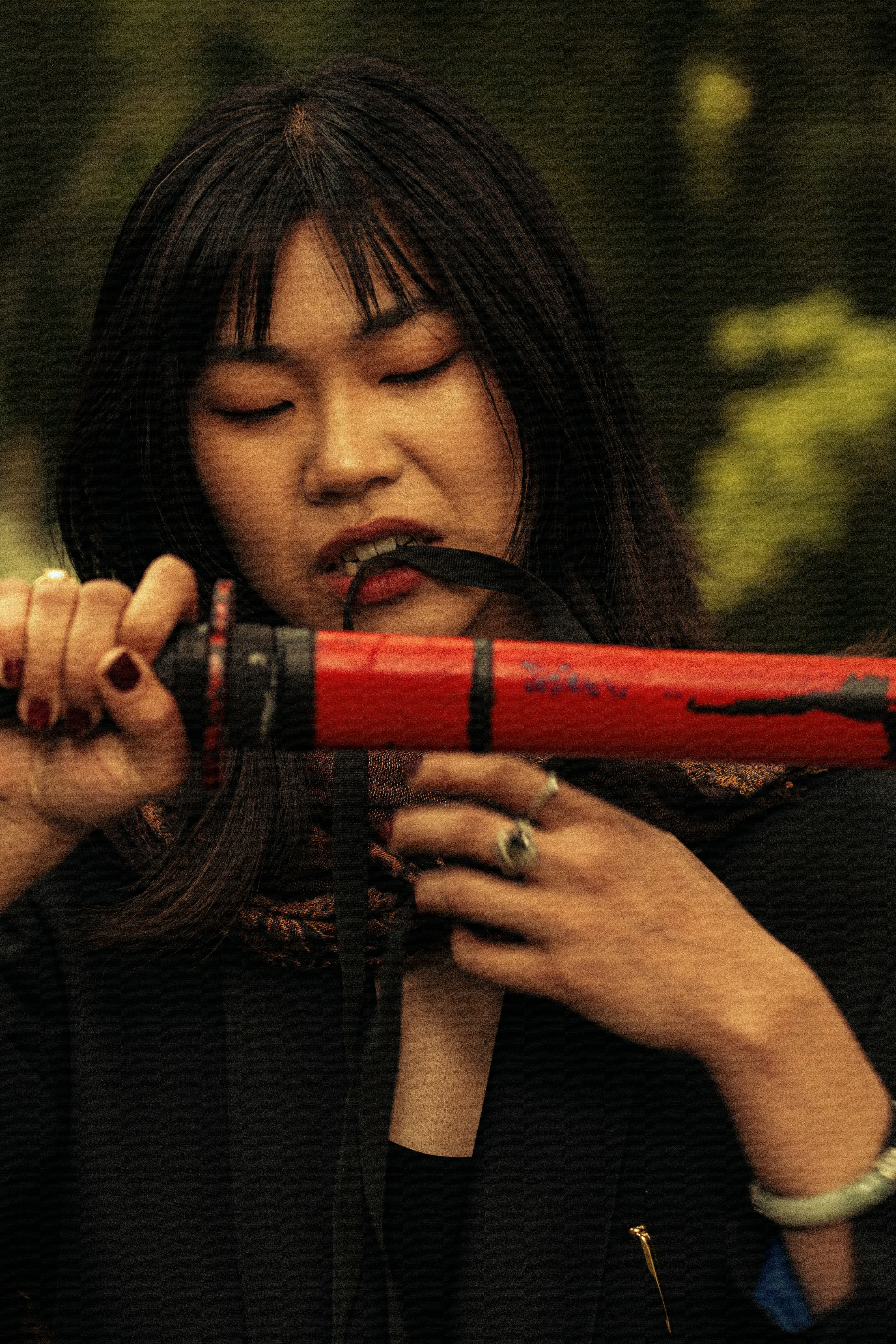 a woman holding a red object in her hands