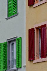 Exterior house facade freshly painted in a clean, bright white with contrasting dark shutters.