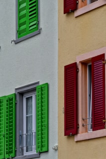 A row of colorful shutters with new handles shining in natural light