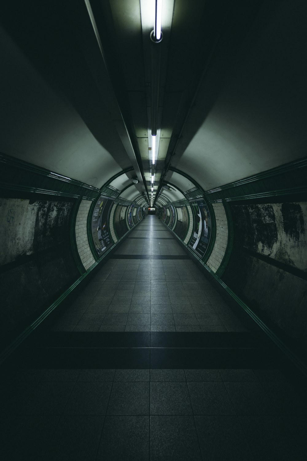 a long hallway with a light at the end of it