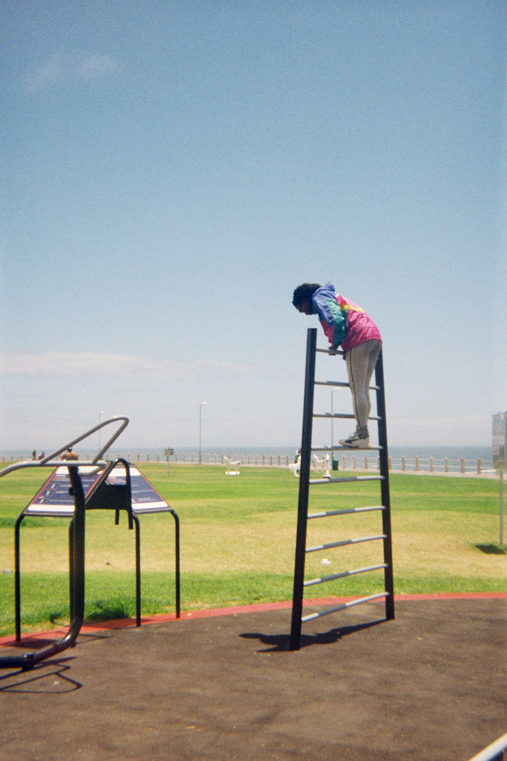 a man on a ladder working on a solar panel