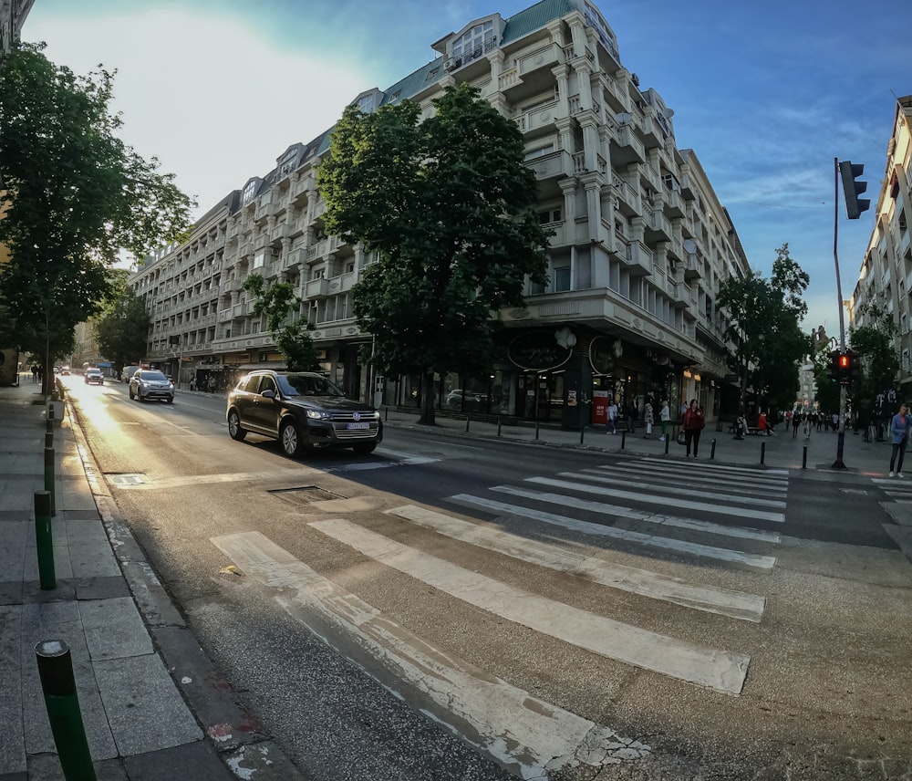 a city street filled with lots of traffic next to tall buildings