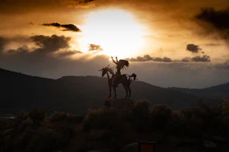 A serene sunrise over a vast American landscape, symbolizing the enduring spirit of indigenous peoples.