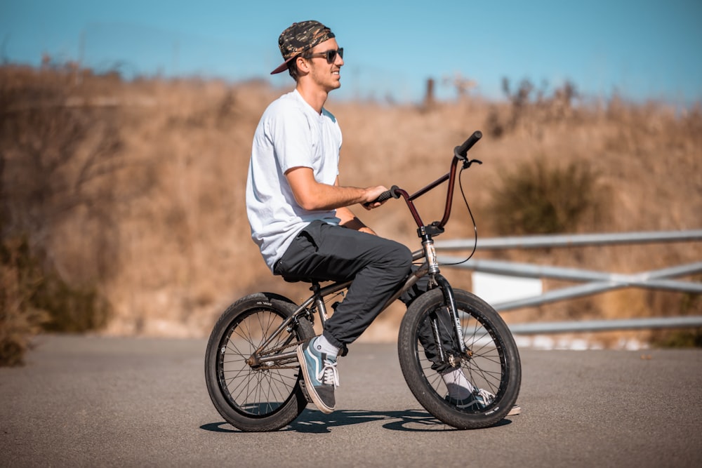 a man riding a bike down a street