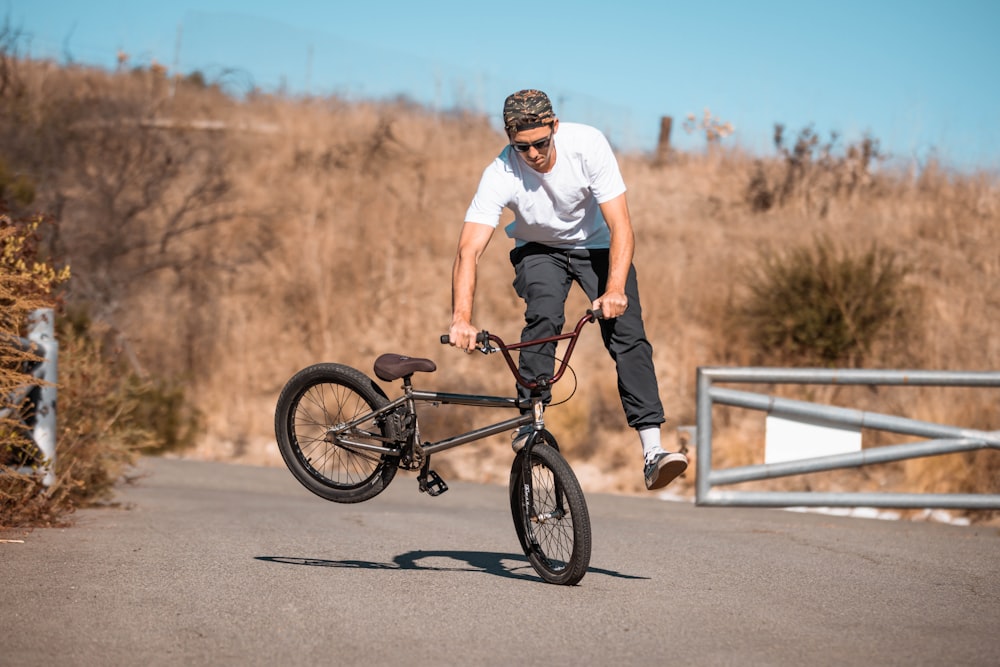 a man is doing a trick on a bicycle