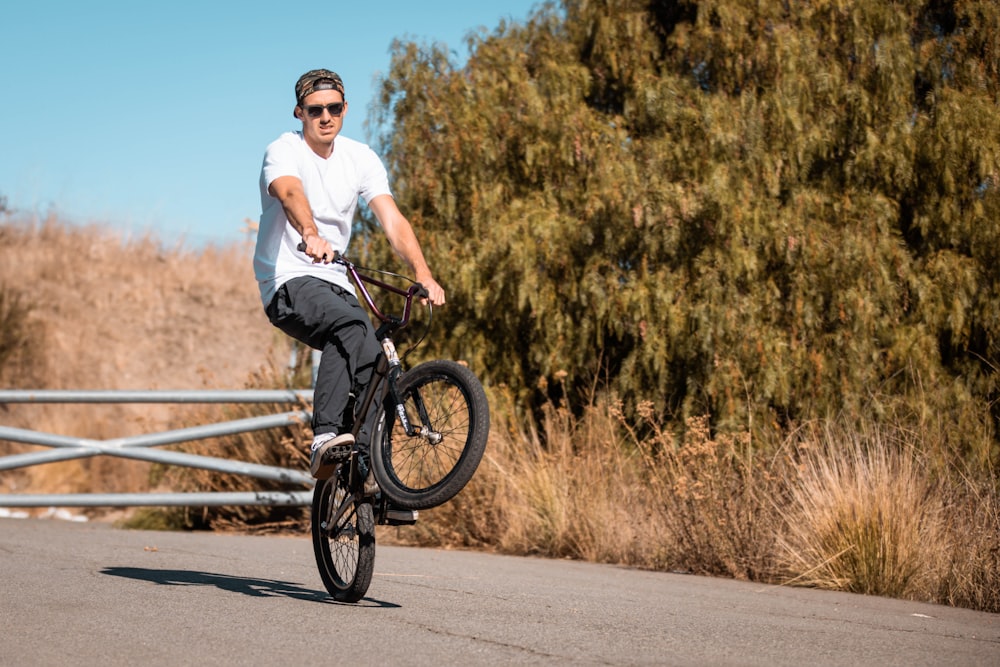 a man riding a bike down a street