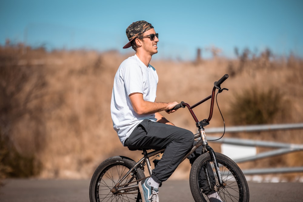 a man riding a bike down a street