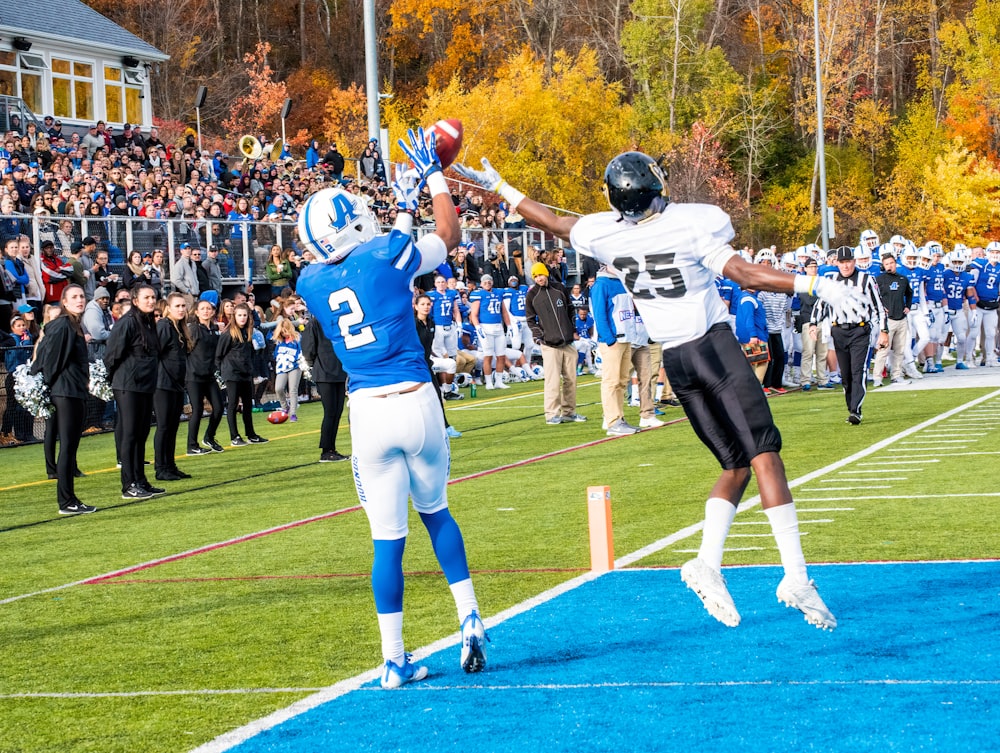 a football player jumping into the air to catch a ball