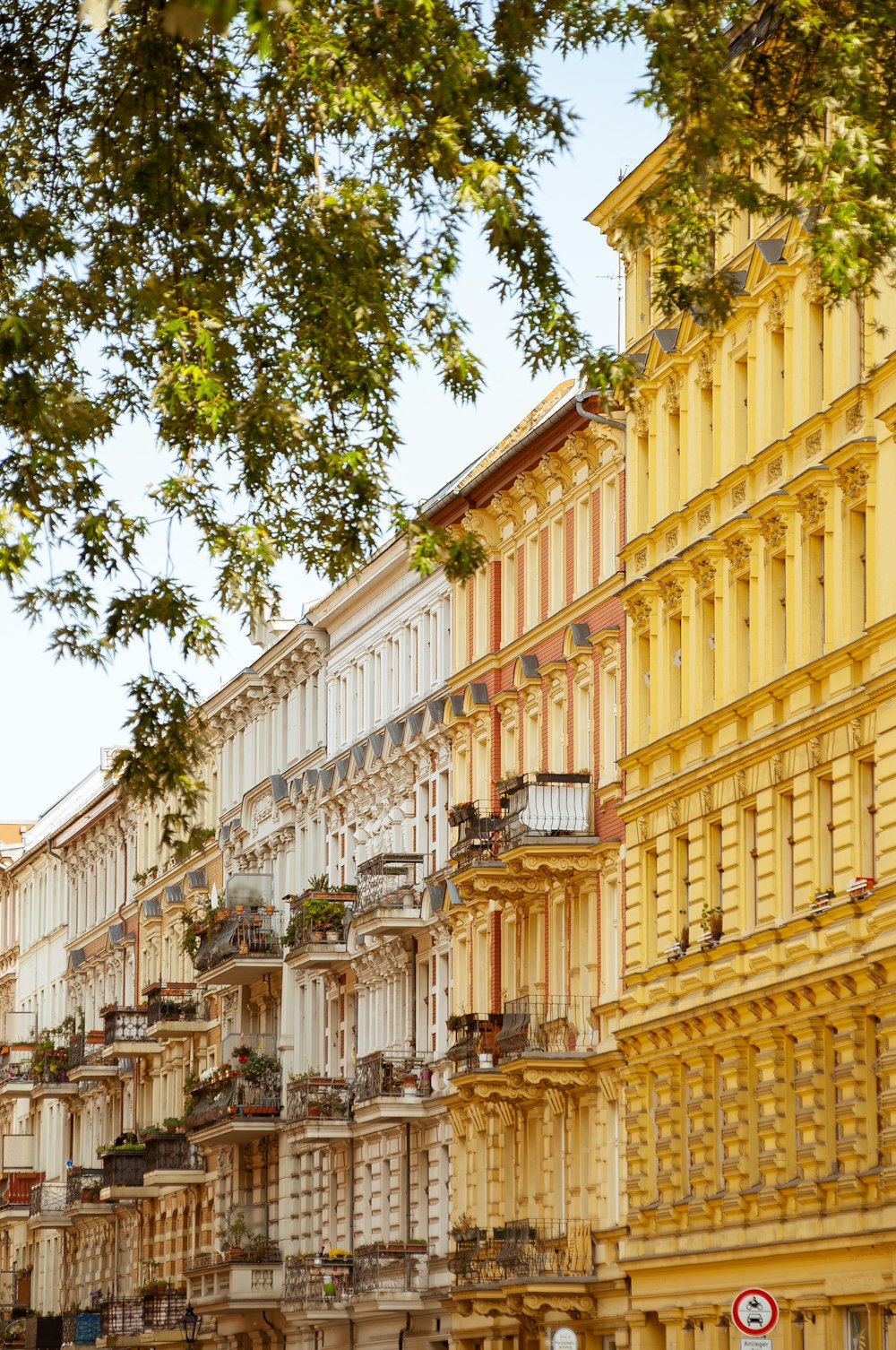 a row of yellow buildings on a city street