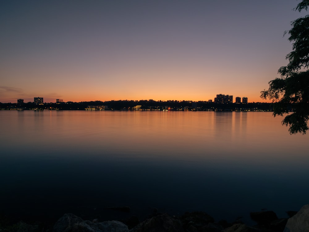 a large body of water with a city in the background