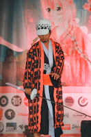A street-style anime character inspired by the vibrant energy of Kashi, wearing graphic merch with spiritual motifs.