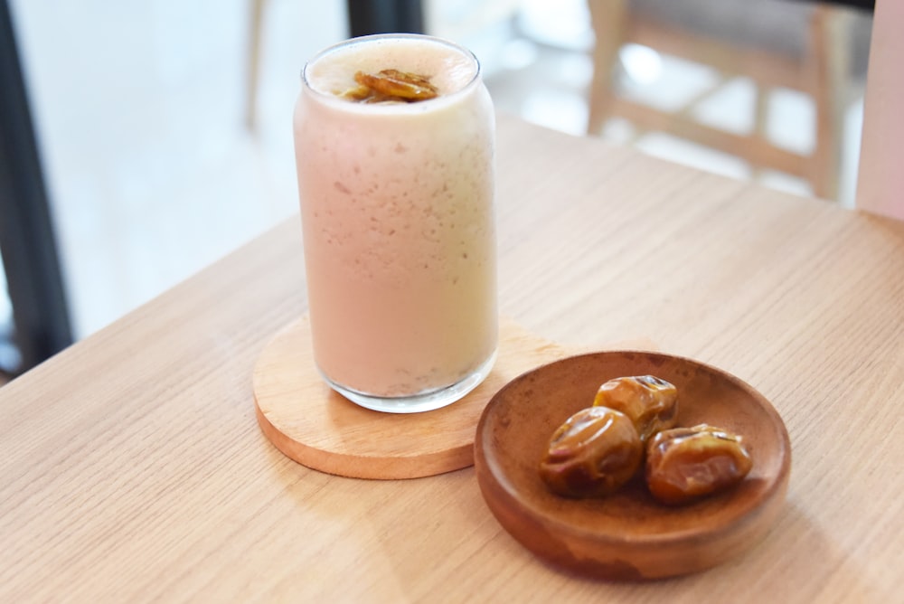 a glass of milk and some food on a table