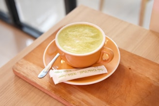 A cheerful moment of a customer enjoying a cup of âu trà in a cozy, green-themed setting.