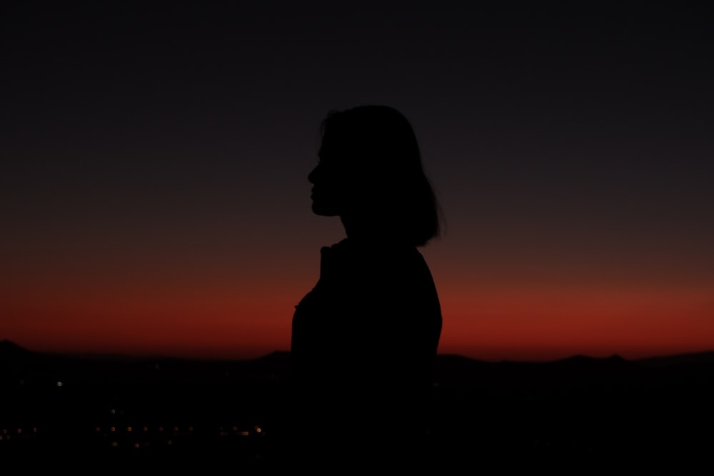 a silhouette of a person in the dark