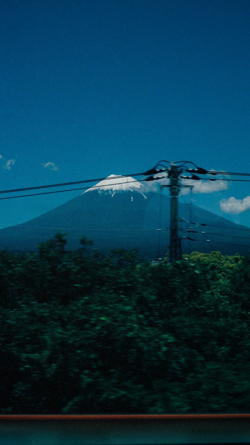 a view of a mountain from a moving train