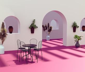 a room with a table and chairs and potted plants