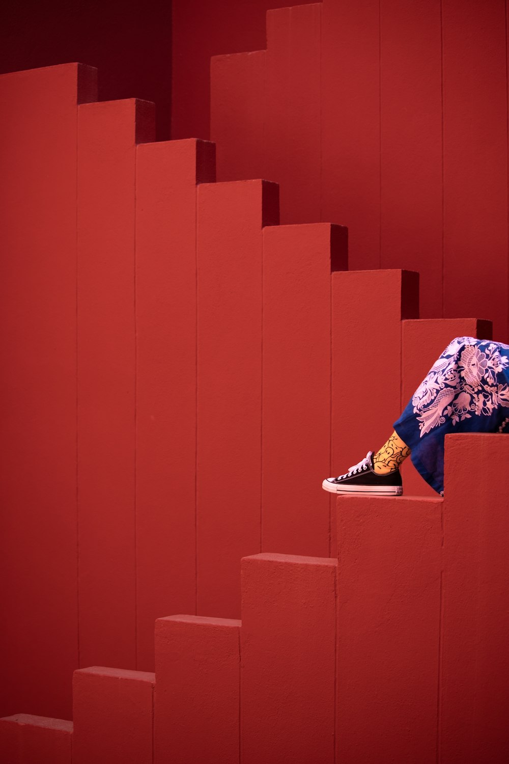 a person is sitting on a stair case