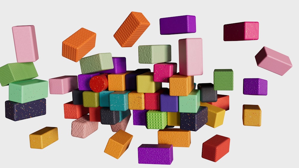 a pile of colorful blocks and bricks on a white background
