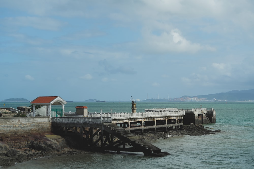 a pier with a small house on top of it